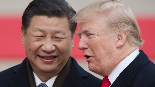 China's President Xi Jinping (L) and US President Donald Trump attend a welcome ceremony at the Great Hall of the People in Beijing on November 9, 2017. 