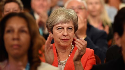 BIRMINGHAM, ENGLAND - SEPTEMBER 30:  British Prime Minister Theresa May applauds as she sits in the audience during the annual Conservative Party Conference on September 30, 2018 in Birmingham, England. 