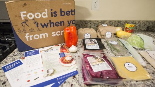 Items from a 'family-plan' Blue Apron box are displayed on a kitchen counter on June 28, 2017 in Boston, Massachusetts. The online meal-kit delivery company is going public and has lowered their upcoming IPO price range from $15 to $17 a share to $10 to $11 a share. 