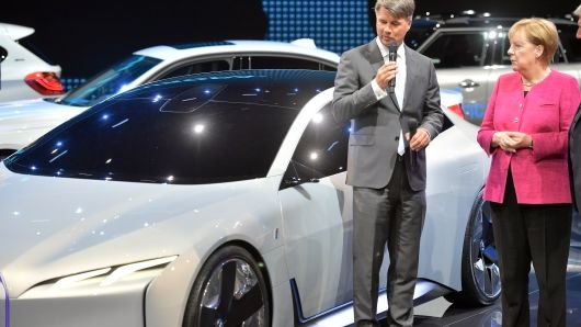 Harald Krueger, CEO of German carmaker BMW shows the German Chancellor Angela Merkel an 'i Vision Dynamic' all-electric concept car at the 2017 Frankfurt Auto Show. 
