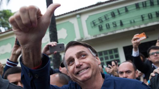 Brazil's right-wing presidential candidate for the Social Liberal Party (PSL) Jair Bolsonaro gives his thumbs up after casting his vote at Villa Militar, during general elections, in Rio de Janeiro, Brazil, on October 7, 2018. 