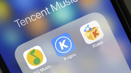 The logos of QQ Music, Kugou and Kuwo are seen on the screen of an iPhone on June 12, 2018 in Paris, France. QQ Music, Kugou and Kuwo are the three streaming Chinese music services owned by Tencent. 