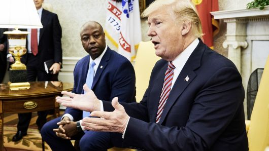 President Donald Trump, right, speaks while Senator Tim Scott, a Republican from South Carolina, listens during a working session regarding the Opportunity Zones provided by tax reform in the Oval Office of the White House in Washington, D.C., U.S., on Wednesday, Feb. 14, 2018. 