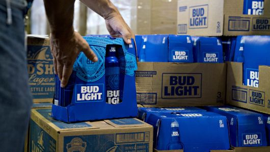 An employee adjusts bottles of Bud Light brand beer at an Anheuser-Busch InBev NV facility in Williamsburg, Virginia, U.S., on Wednesday, Aug. 8, 2018. 