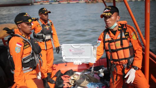 Members of a rescue team bring personal items and wreckage ashore at the port in Tanjung Priok, North Jakarta, Indonesia on October 29, 2018, after they were recovered from the sea where Lion Air flight JT 610 crashed off the north coast earlier in the day.