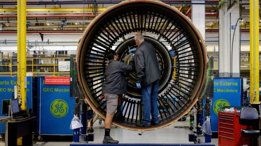 Men work with a jet engine at General Electric (GE) Celma, GE's aviation engine overhaul facility in Petropolis, Rio de Janeiro, Brazil.