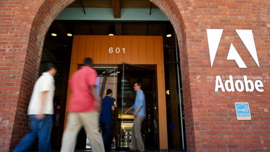 People enter the Adobe Systems Inc. office in San Francisco, California.