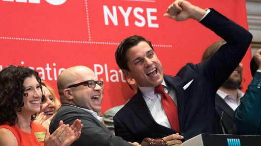 Twilio Inc. founder and CEO Jeff Lawson (C, in glasses) reacts after ringing the opening bell to celebrate Twilio's initial public offering, at the New York Stock Exchange, June 23, 2016 in New York City.