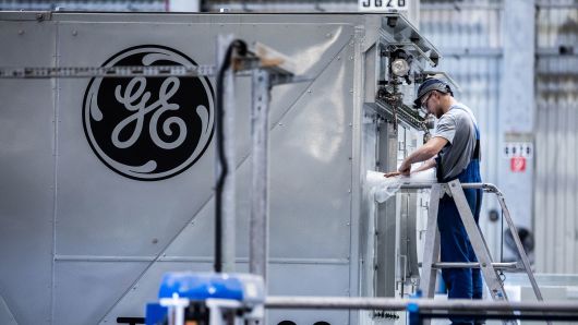 An employee unwraps turbine components inside the General Electric power plant in Veresegyhaz, Hungary.