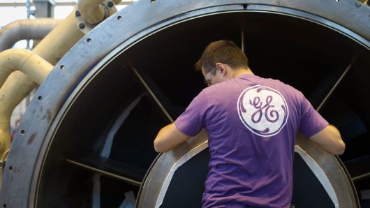An employee of General Electric works on a gas turbine at the GE plant in Belfort, France.