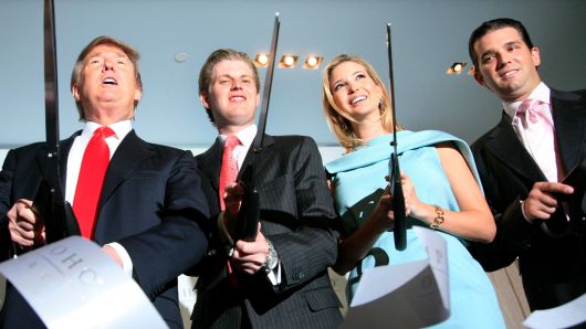 In this April, 2010 file photo, Donald Trump, left, chairman and CEO of the Trump Organization, cuts the ribbon with his children Eric, Ivanka, and Donald Trump, Jr. right, at the opening of the Trump SoHo New York.