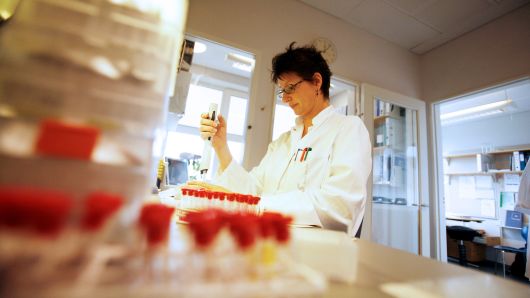 A lab technician at Novo Nordisk conducts in vitro research in Malov, Denmark.