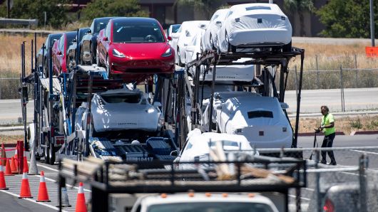 Tesla Model 3 vehicles are loaded onto a truck for transport at the company's manufacturing facility in Fremont, California, on Wednesday, June 20, 2018. 