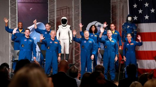 The astronauts assigned to crew the first flight tests and missions of the Boeing CST-100 Starliner and SpaceX Crew Dragon acknowledge the media upon introduction at NASA's Johnson Space Center in Houston, Texas, U.S., August 3, 2018. The astronauts are (L to R): Victor Glover, Robert Behnken, Michael Hopkins, Douglas Hurley, Eric Boe, Sunita Williams, Christopher Ferguson, Josh Cassada, and Nicole Mann.