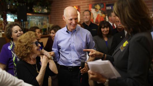 Florida Governor Rick Scott greets people as he makes a campaign stop at Chico's Cuban Restaurant where he received an endorsement from the Florida Police Chiefs Association on June 14, 2018 in Hialeah, Florida. 