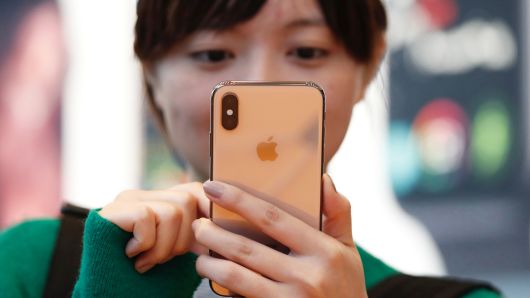 A customer looks at Apple's new iPhone XS after it went on sale at the Apple Store in Tokyo, Japan, September 21, 2018.