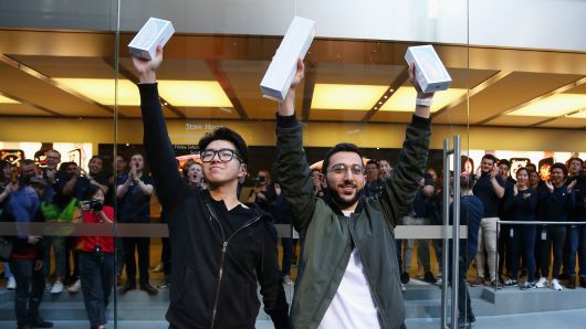 Teddy Lee and  Mazen Kourouche pose with their  iPhone Xs  during the Australian release of the latest iPhone models at Apple Store on September 21, 2018 in Sydney, Australia. 