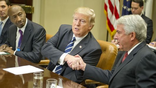President Donald Trump shakes hands with Robert J. Hugin, Executive Chairman, Celgene Corporation, as he meets with representatives from PhRMA, the Pharmaceutical Research and Manufacturers of America in the Roosevelt Room of the White House on January 31, 2017 in Washington, DC. 
