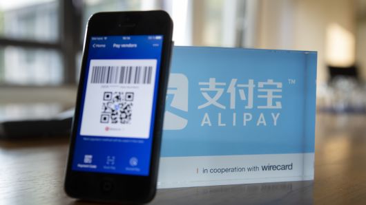 An Alipay digital payment app logo and smartphone sit on a desktop at the Wirecard AG headquarters in Munich, Germany, on Wednesday, Sept. 5, 2018.