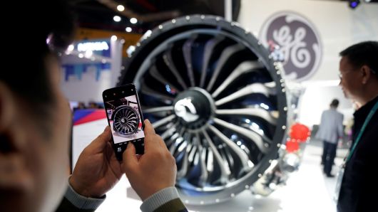A man takes a picture of a General Electric (GE) engine during the China International Import Expo (CIIE), at the National Exhibition and Convention Center in Shanghai, China November 6, 2018.