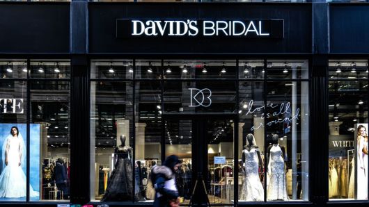 A pedestrian passes in front of a David's Bridal Inc. store in New York, U.S., on Wednesday, Nov. 14, 2018. 