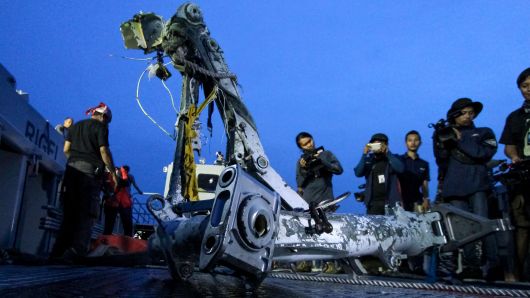 Members of the search team lift part of the landing gear of the ill-fated Lion Air flight JT 610 during search operations at sea off the coast from Karawang on November 5, 2018.