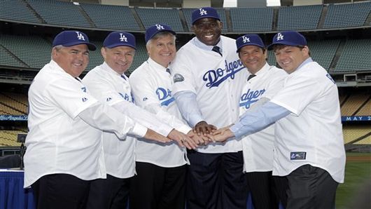 New owners of the Los Angeles Dodgers, from left, Robert Patton, Stan Kasten, Mark Walter, Earvin "Magic' Johnson," Peter Guber, and Todd Boehly pose for a photo at Dodger Stadium in Los Angeles on Wednesday, May 2, 2012. The $2 billion sale of the team to Guggenheim Baseball Management was finalized Tuesday. (AP Photo/Damian Dovarganes)