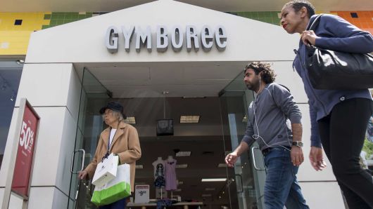 Pedestrians walk past a Gymboree store in San Francisco, California.