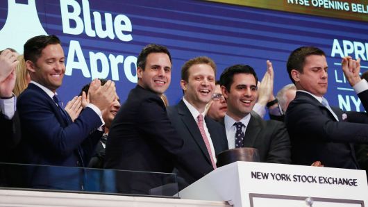 Blue Apron CEO Matthew B. Salzberg, center, celebrates with co-founders Ilia Papas, second from right, and Matt Wadiak during the company's IPO on the New York Stock Exchange in New York, June 29, 2017.