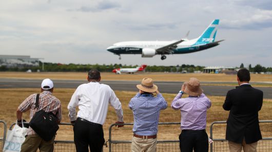 Spectators watch a Boeing Co. 737 Max 7 jetliner land on the opening day of the Farnborough International Airshow 2018 in Farnborough, U.K., July 16, 2018.