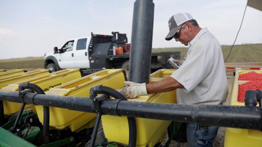 Farmer Bruce Elder, 56, a farmer for 40 years, fills a seeding container with soybean seeds in Gideon, Missouri. 