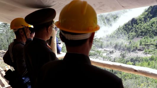 In this handout image provided by the News1-Dong-A Ilbo, North Korean officials watch the demolition of the Punggye-ri nuclear test site on May 24, 2018 in Punggye-ri, North Korea. 