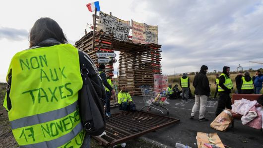 Yellow vests (Gilets jaunes) protesters block the road leading to the Frontignan oil depot in the south of France, as they demonstrate  against the rise in fuel prices and the cost of living on December 3, 2018. 