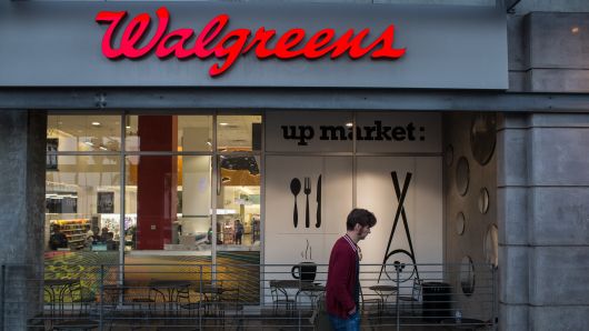 A pedestrian passes in front of a Walgreens Boots Alliance Inc. store in the Hollywood neighborhood of Los Angeles, California.