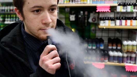 Nick Gregory, a 26-year-old manager, vapes on a JUUL at Botany Bay in Lexington, Ky. Several Lexington high schools are concerned about an increase in student vaping.