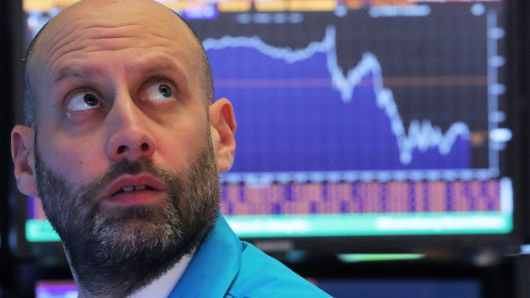 A trader works at his post on the floor of the New York Stock Exchange, December 19, 2018.