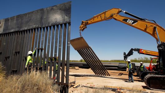 Construction workers are seen next to heavy machinery while working on a new border wall in Santa Teresa, New Mexico, as seen from the Mexican side of the border in San Jeronimo, on the outskirts of Ciudad Juarez, Mexico April 23, 2018.