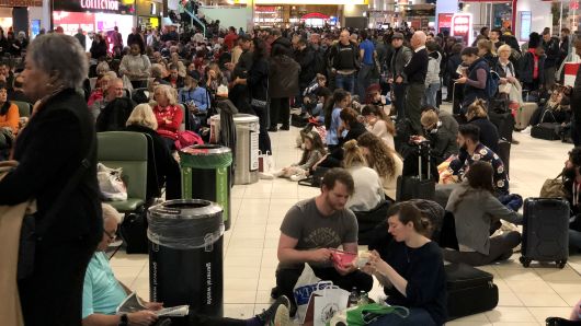 Passengers stranded at Gatwick wait for updates on their travel options on December 20, 2018.