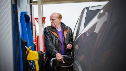 Jim Pattison, chief executive officer and founder of Jim Pattison Group Inc., pumps gas into a pickup truck during a tour of his holdings near Russell, Manitoba, Canada, on Tuesday, Sept. 18, 2018.