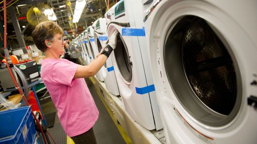 An employee works on a Whirlpool washing machine at the company's operations plant in Clyde, Ohio.