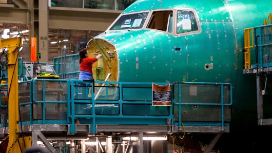 An employee works on the nose of a Boeing airplane at the company's facility in Everett, Washington.