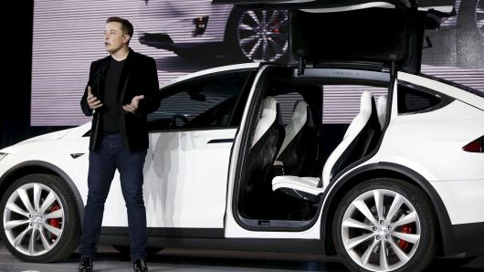 Tesla Motors CEO Elon Musk introduces the "falcon wing" door on the Model X electric sports-utility vehicle during a presentation in Fremont, California, on September 29, 2015.