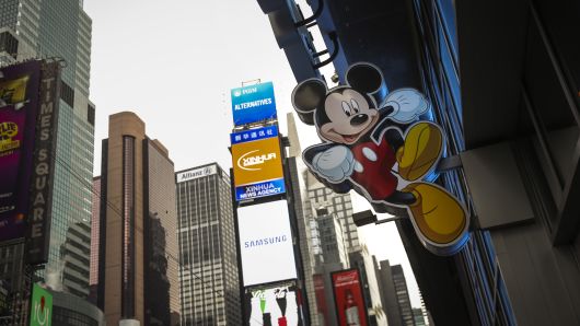 An image of Mickey Mouse, the official mascot of The Walt Disney Company, is displayed outside the Disney Store in Times Square in New York City.