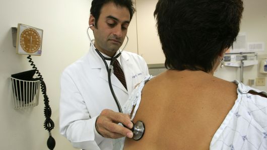 A doctor examines a patient at the UCSF Women's Health Center in San Francisco, California.