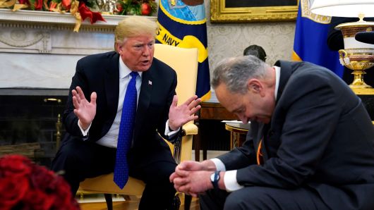 President Donald Trump speaks with Senate Democratic Leader Chuck Schumer (D-NY) in the Oval Office of the White House in Washington, U.S., December 11, 2018.