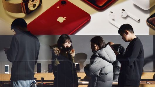 Customers look at products in an Apple store in Beijing on December 11, 2018.