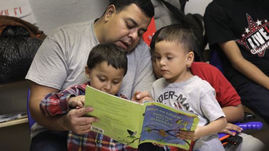 Immigrant children read at an aid center after being released from U.S. government detention in McAllen, Texas. U.S. Customs and Border Protection (CBP), and ICE, dealing with a surge of asylum seekers, have been releasing recently arrived families, pending immigration court dates, despite continued official 'zero tolerance' immigration policies.
