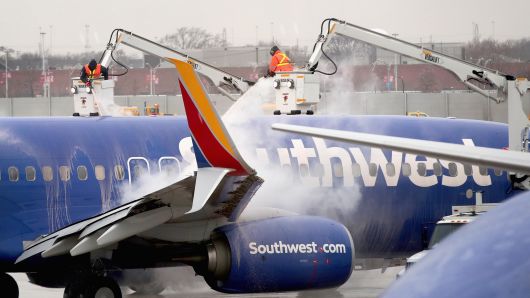Workers deice a Southwest Airline aircraft at Midway Airport on January 22, 2019 in Chicago, Illinois.