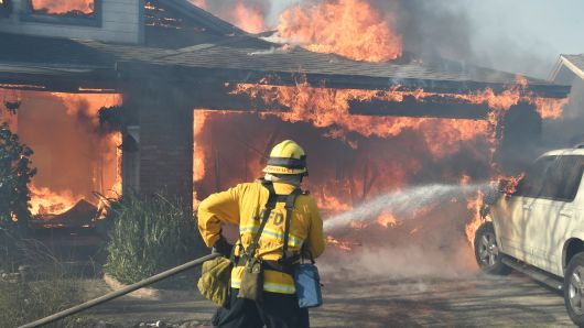 Firefighters battle to save one of many homes burning in an early-morning Creek Fire that broke out in the Kagel Canyon area in the San Fernando Valley north of Los Angeles, in Sylmar, California, U.S., December 5, 2017.