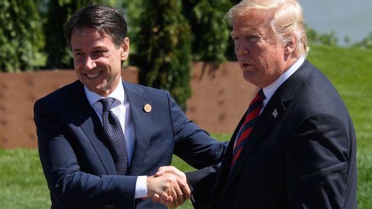 Italy's Prime Minister Giuseppe Conte (L) shakes hands with the President of the United States Donald Trump on the first day of the G7 Summit.